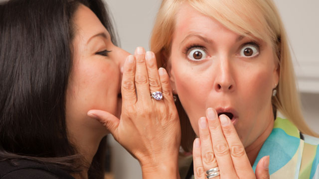 A lady is telling secrets and the other lady is surprised by the secret.
